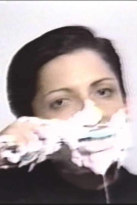 The piece, originally a 1975 photoperformance, was later re‑imagined ten years on as Lenora’s first videoperformance, honoring the solitary, plaintive figures created by American sculptor George Segal. In front of the camera she brushes her teeth at full force while The Beatles’ “She Loves You” plays; foam builds up and eventually engulfs her face and head, echoing Segal’s haunting characters.